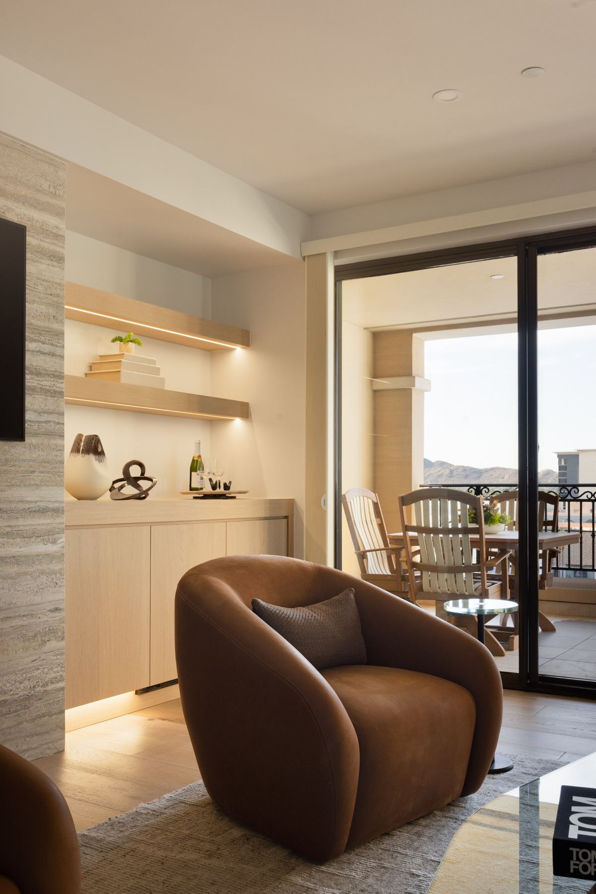 Lounge corner with lit shelving & patio access