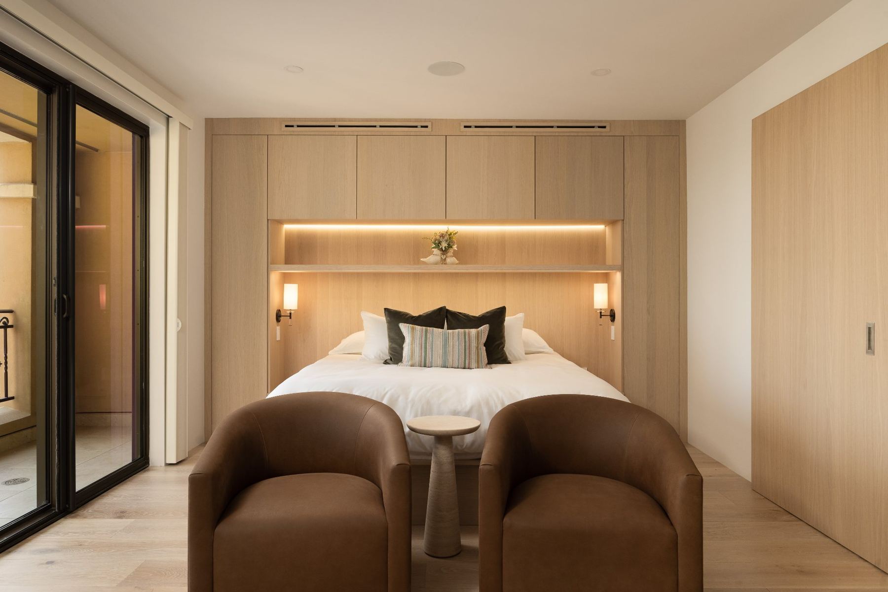 Primary suite with backlit headboard wall