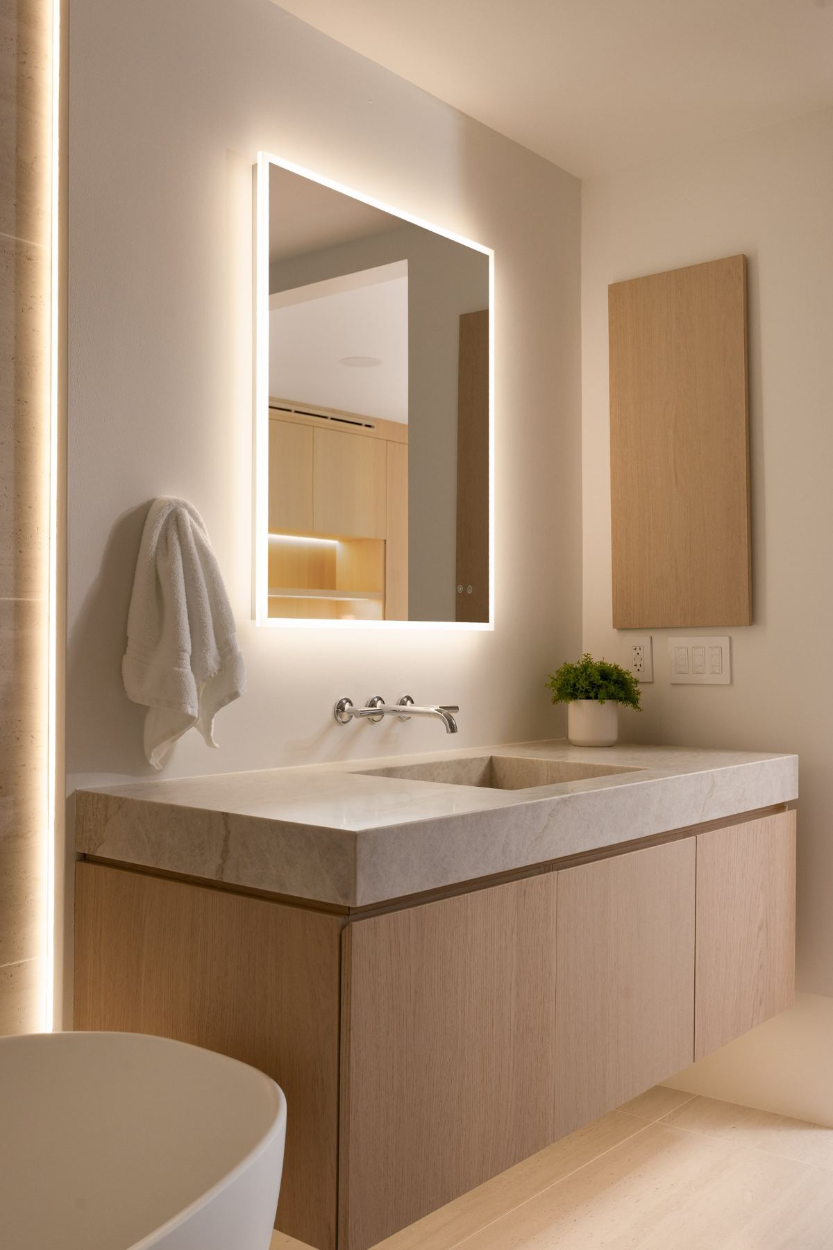 Floating vanity with backlit mirror